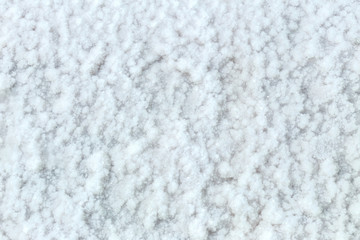 Sea salt mining, produced from the evaporation of seawater, close up background.