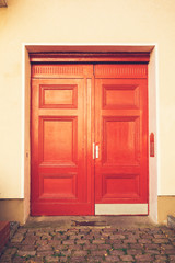 red door on yellow facade