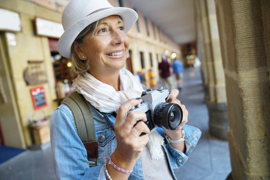 Senior woman taking pictures on tourist journey