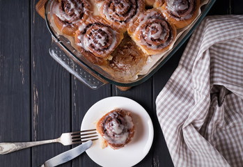 Homemade cinnamon rolls on the black table