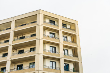 modern yellow apartment house in berlin with balcony