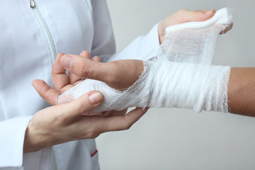 A nurse bandages a patient's hand
