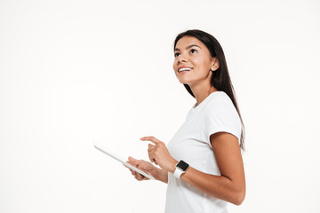 Portrait of a young happy woman holding tablet computer