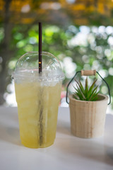 Cool glass of lemonade with straw