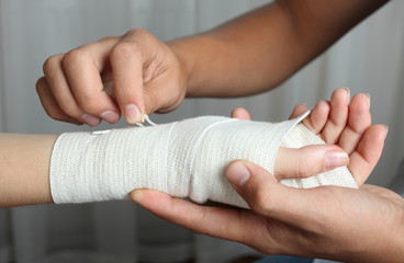  guy bandages the girl's hand