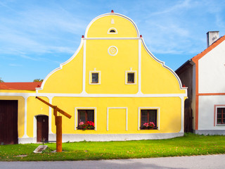 Fototapeta premium Picturesque house of Holasovice, small rural village with rustic baroque architecture. Southern Bohemia, Czech Republic. UNESCO heritage site.