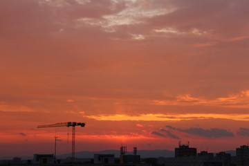 Fototapeta na wymiar Ceske Budejovice with crane silhouette in orange sunset sky