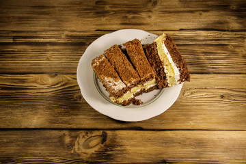 Sour cream cake on plate on wooden table