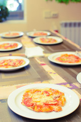 children cook pizza from raw ingredients