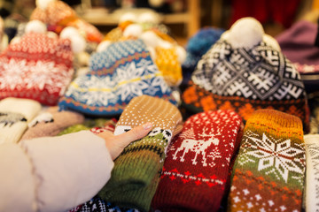 woman buying woolen mittens at christmas market