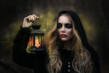 Halloween. beautiful girl witches in the woods with pumpkins