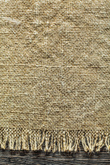 Vintage sacking textile on wooden board
