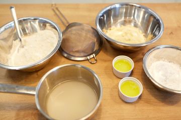 bowls with flour and egg whites at bakery kitchen