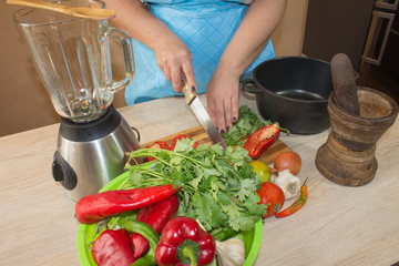 Chef cuts the vegetables into a meal. woman hands cutting vegetables on kitchen blackboard. Woman preparing vegetables