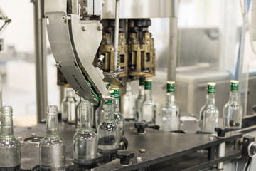 The mechanism of the automatic bottle capping machine.