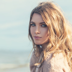 Young Woman Fashion Model with Long Curly Hairstyle Outdoors