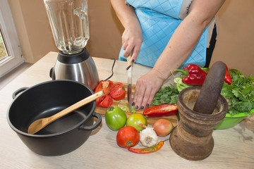woman cooking healthy meal in the kitchen. Cooking healthy food at home. Woman in kitchen preparing vegetables