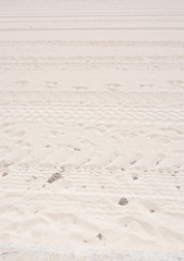 Tracks and footprints on sandy beach