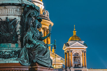 Fototapeta na wymiar Night view of the ancient statues of stucco and the dome of St. Isaac's Cathedral Saint-Petersburg.