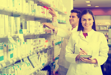 Portrait of two friendly pharmacists working