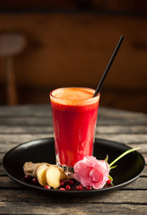 Fresh red smoothie made of ginger and pomegranate