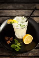 Fresh lemonade with mint leaves on wooden table