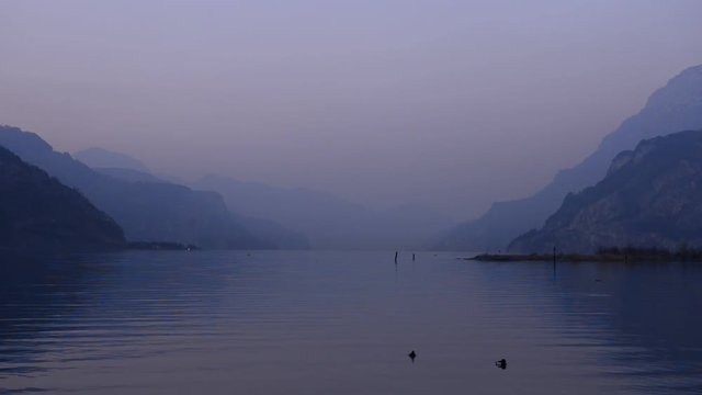 Lilac evening at the lake. Overcast. Evening landscape. Mountain range. Lake with calm water. Lake Lucerne.