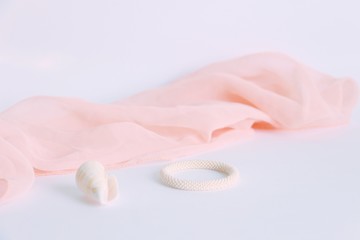 Fototapeta na wymiar bead crochet bracelet with silk scarf and sea shell
