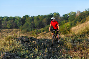 Bike adventure travel photo. Cyclist on the Beautiful Meadow Trail on sunny day.