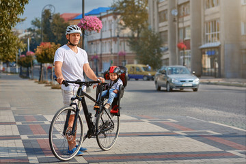 Cheerful family biking in park