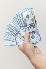 Vertical photo. Fan of One Hundred Dollars notes