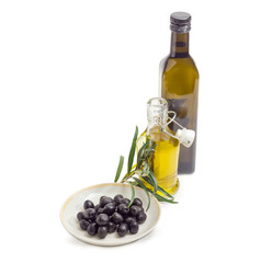 Black olives, two bottles of olive oil and olive branch