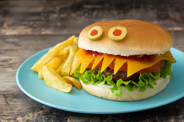 Halloween burger monsters on wooden table
