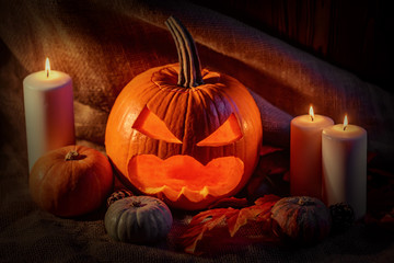 Halloween pumpkin head with burning candles