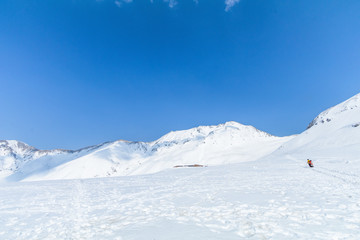  The snow mountains  of Tateyama Kurobe alpine  with blue sky  background is  one of the most important and popular natural place in Toyama Prefecture, Japan.