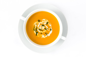 Pumpkin soup in white bowl isolated on white background