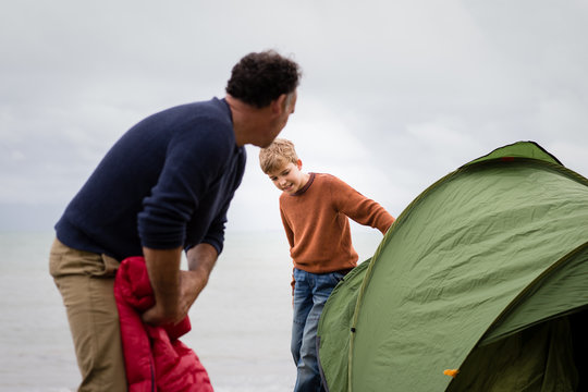 Father and Son putting up a tent together