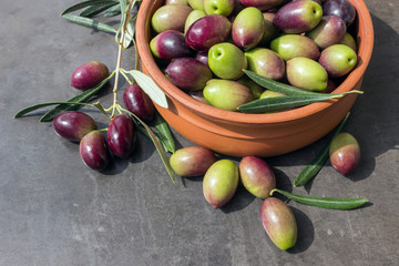 Ripe dark olives in a ceramic bowl. Concept - Mediterranean cuisine, vegetarianism and longevity.