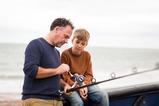 Father teaching Son how to fish
