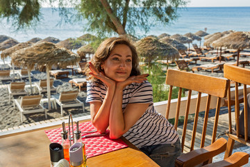 Young woman at the beach cafe