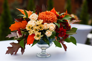 autumn bouquet in a vase on a white table