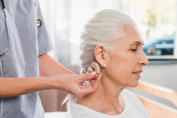 nurse and patient with hearing aid