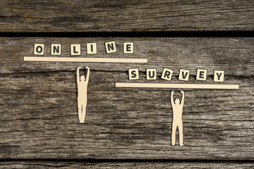 Figures supporting letter tiles spelling online survey
