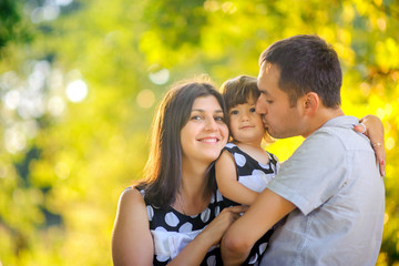 happy family walking in beautiful autumn park at sunset