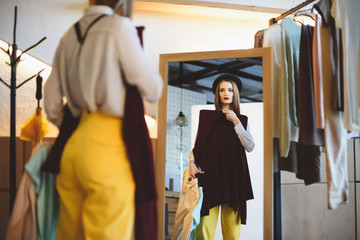 girl in hat choosing clothes