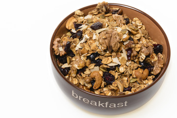 Breakfast: Bowl of whole grain muesli isolated on white background