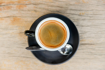 A cup of black coffee in coffee break time on wooden table background.
