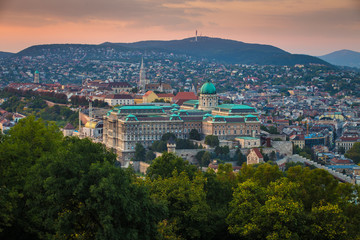 Budapest, Hungary - Panoramic skyline view of the famous Buda Castle Royal Palace with the Buda Hills and Matthias Church at background at sunset