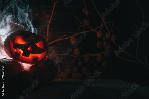 Pumpkin to celebrate Halloween on a wooden background