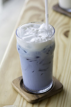 Iced Butterfly Pea Milk on the wooden  table